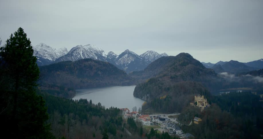 An isolated neighborhood sits near a lake near a mountain range