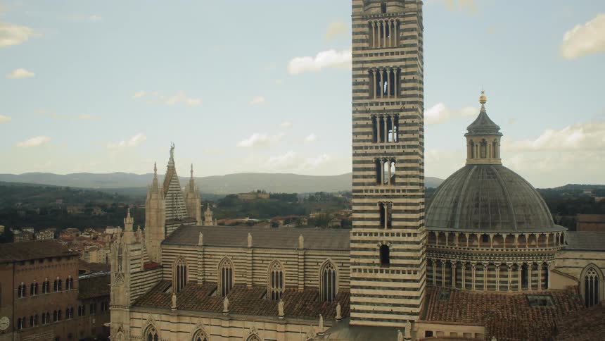 A tower with a neighborhood and the sky in the background