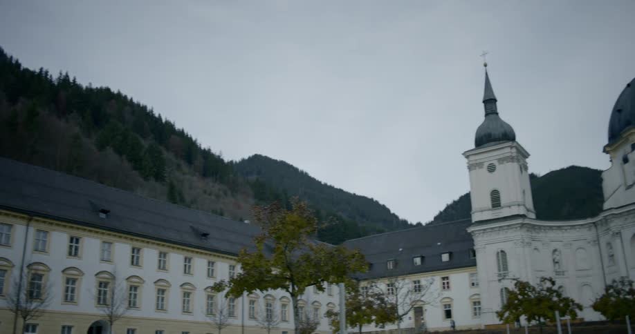 A white palace with a blue roof in the mountains