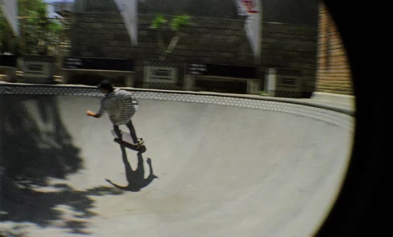 A man rides a skateboard at a skate park