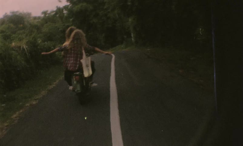 Two people are riding on a motorcycle