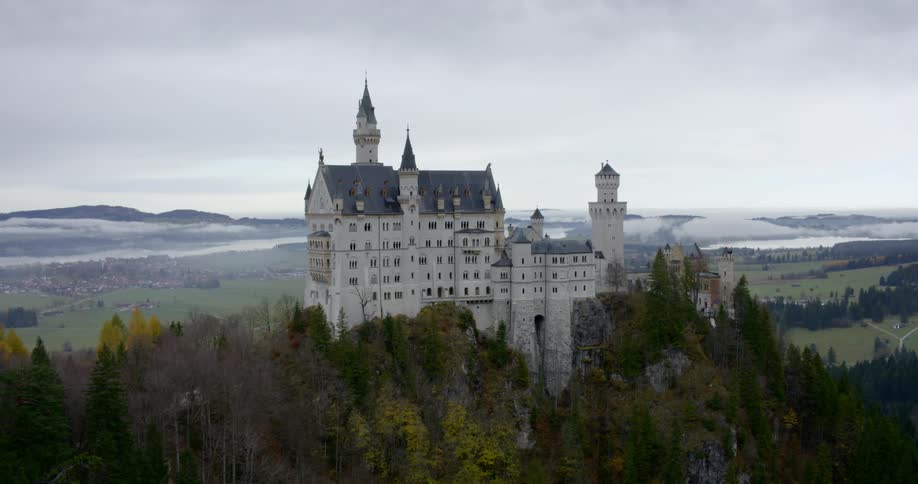 An aerial view of a castle in the middle of forest