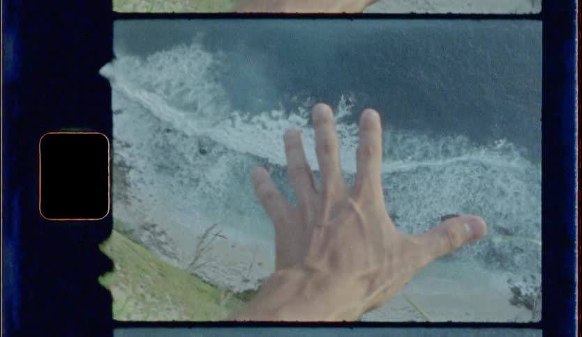 A man moves hand toward water