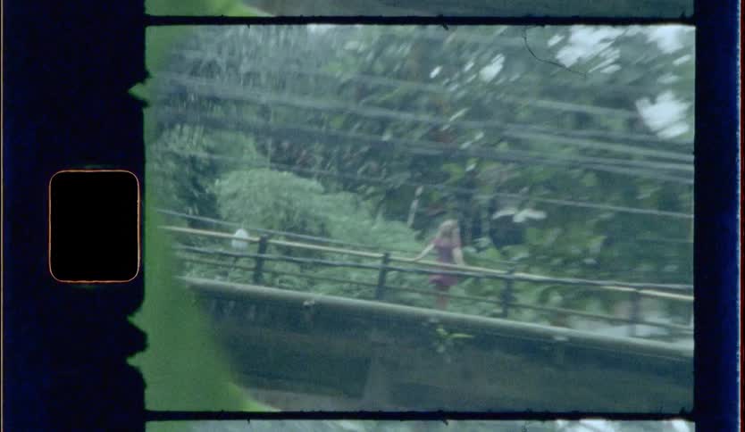 Video footage of a woman standing on a bridge