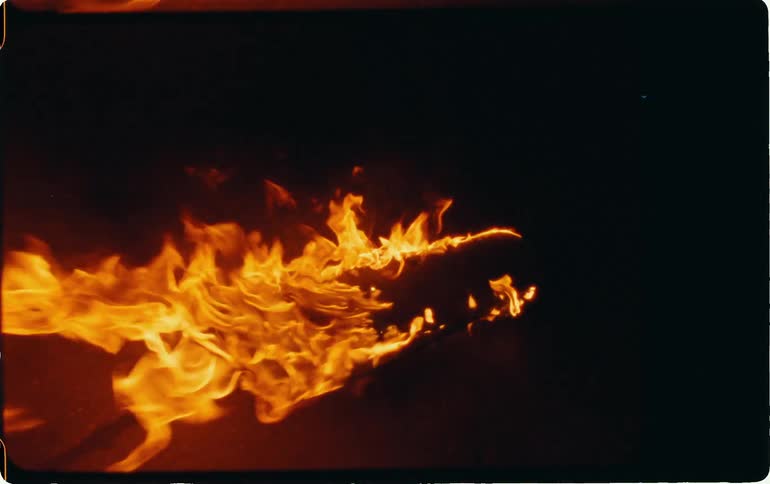 The log is on fire at night