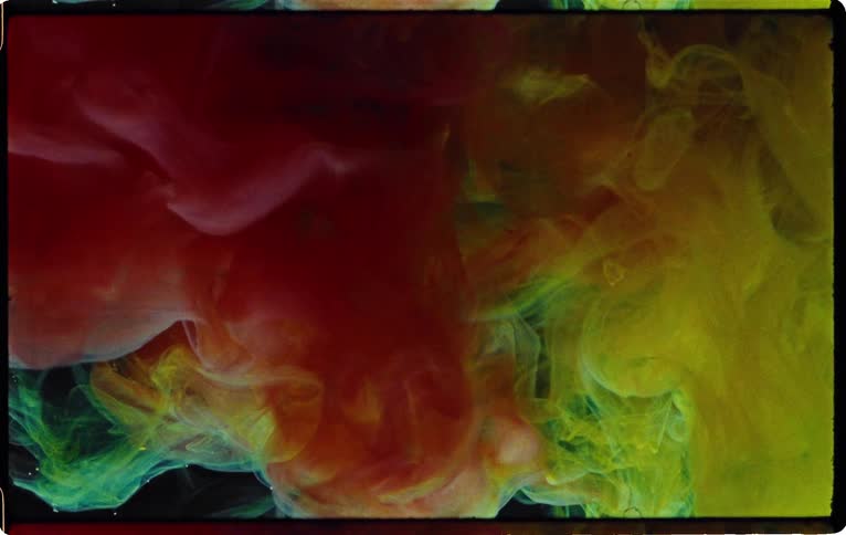 Colors swirl about in liquid and a light flashes
