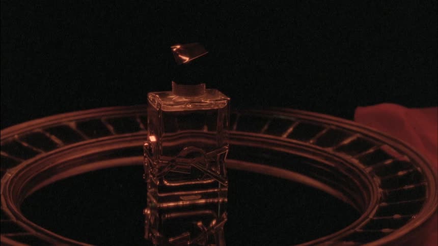 A silver tray with a perfume bottle