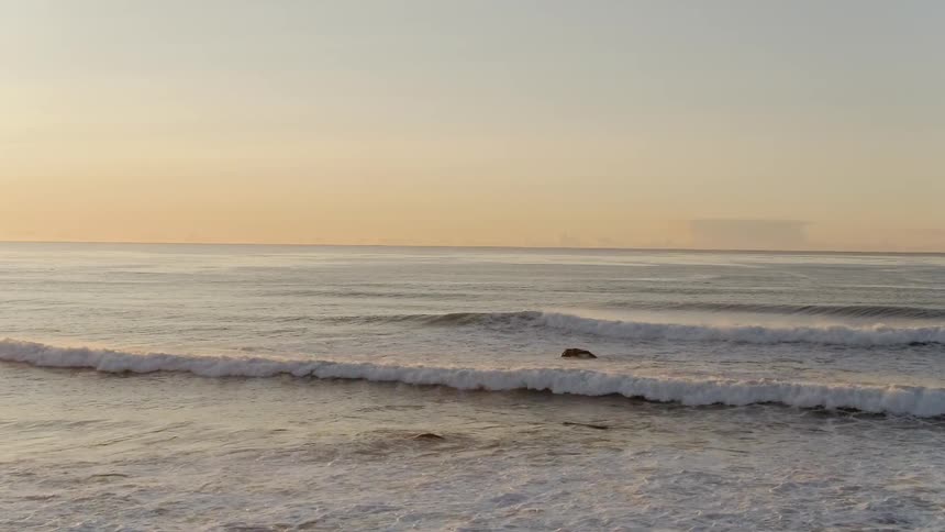 Landscape view of waves crashing towards the shore