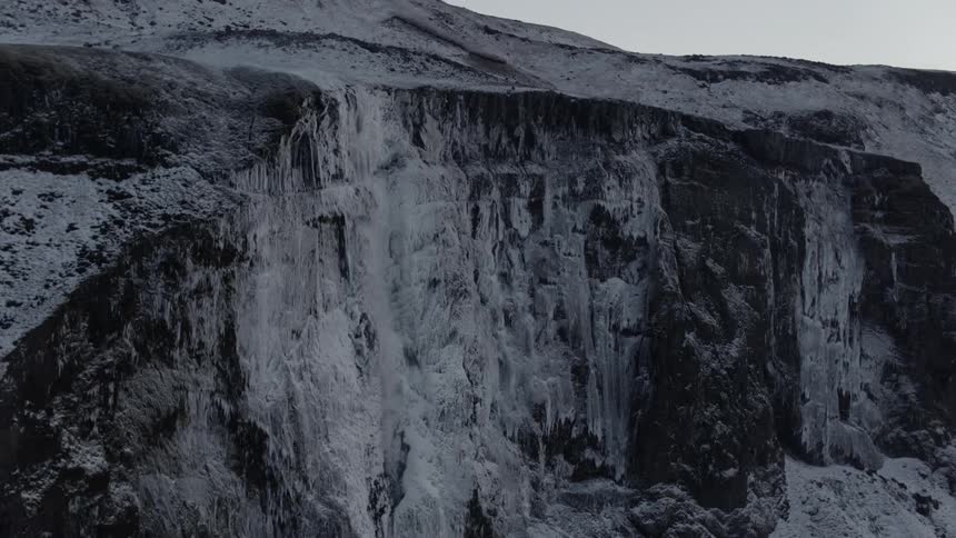An aerial view of a rocky and icy mountain