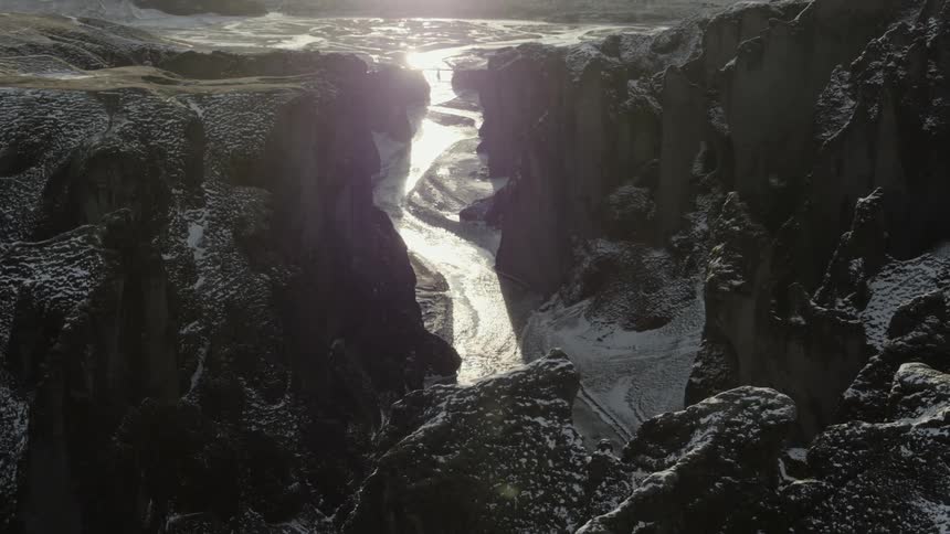 Snow covers pass bordered by cliffs
