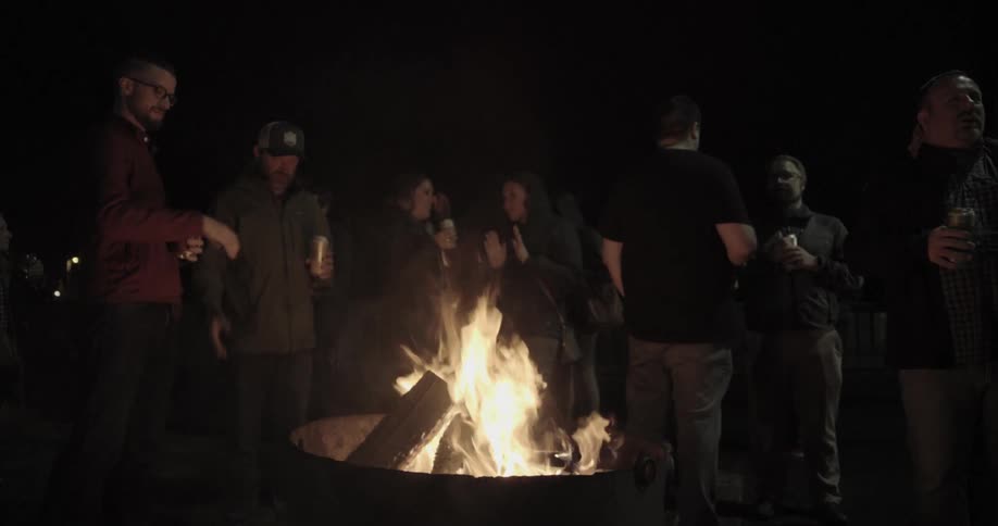 A group of people in front of the camp fire