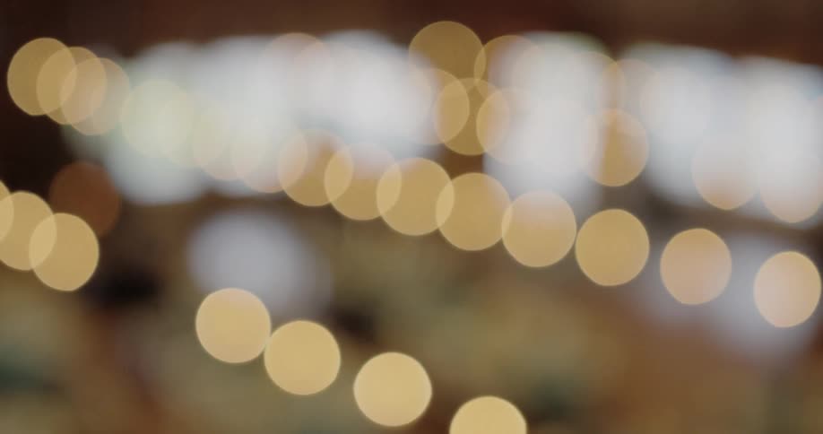 A string of yellow lights are out of focus