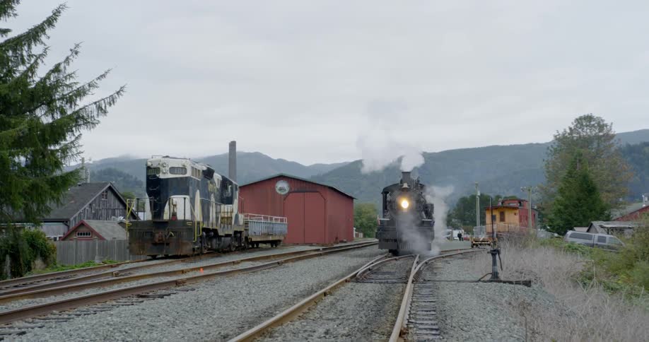 The train is giving off steam at the station