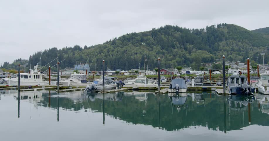 People work on a boat in a marina