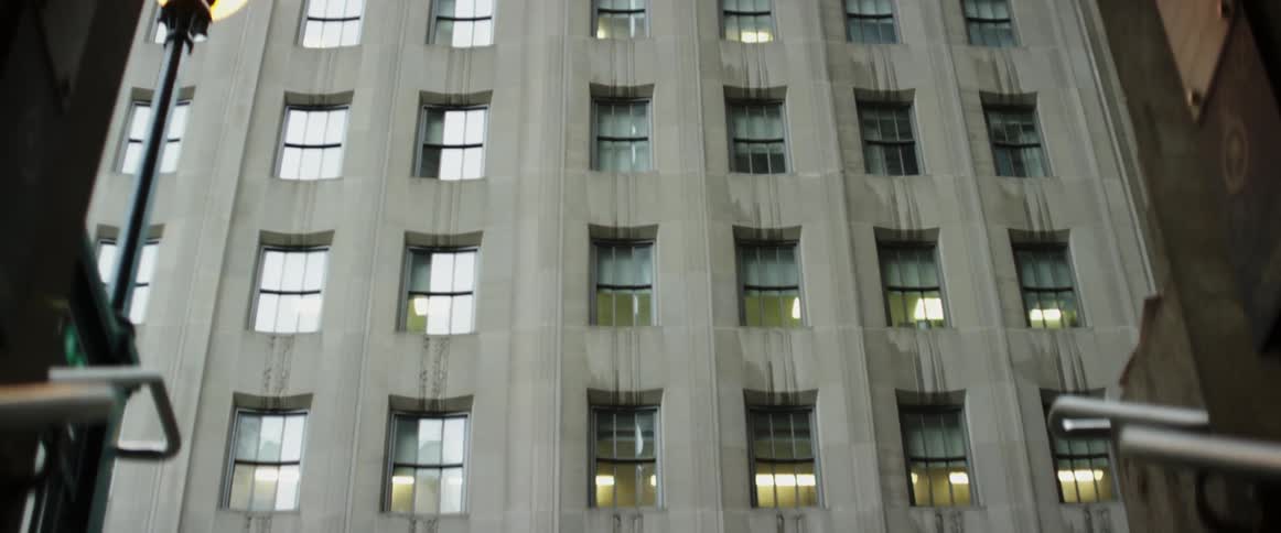 A large building has many windows on a sunny day