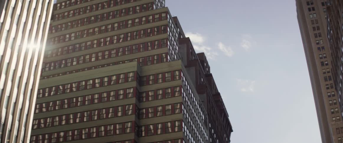 Rows of large buildings are shown on a sunny day