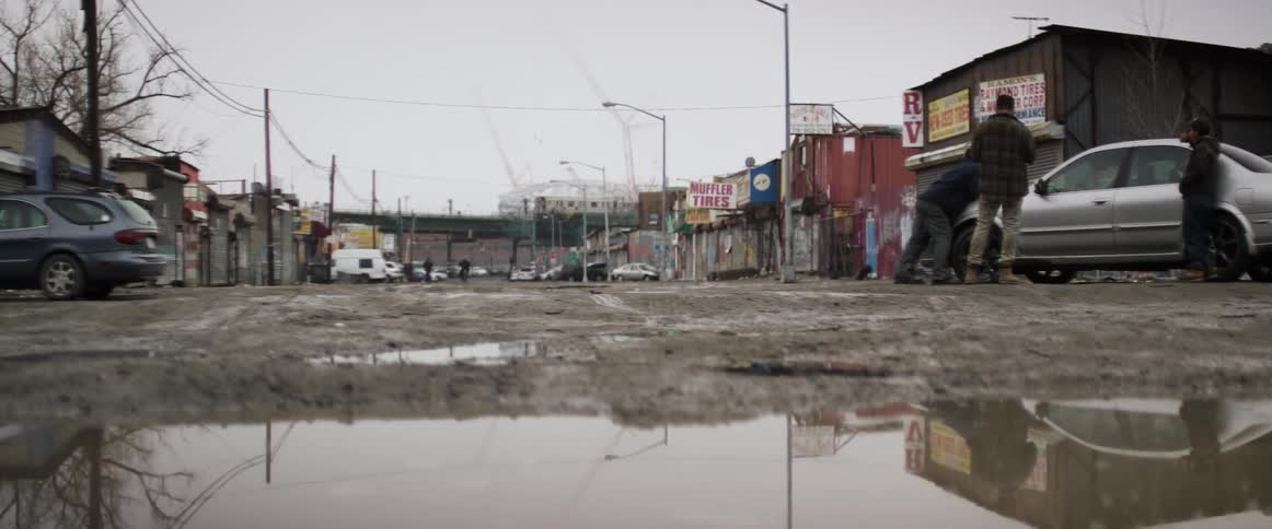 People stand in a slummy city area