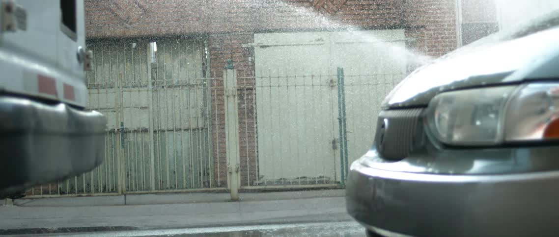 Slow motion show of water spraying on a city street