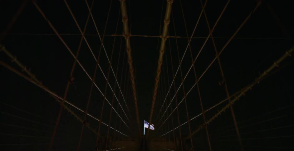 Going across a large bridge at night and panning up to the sky
