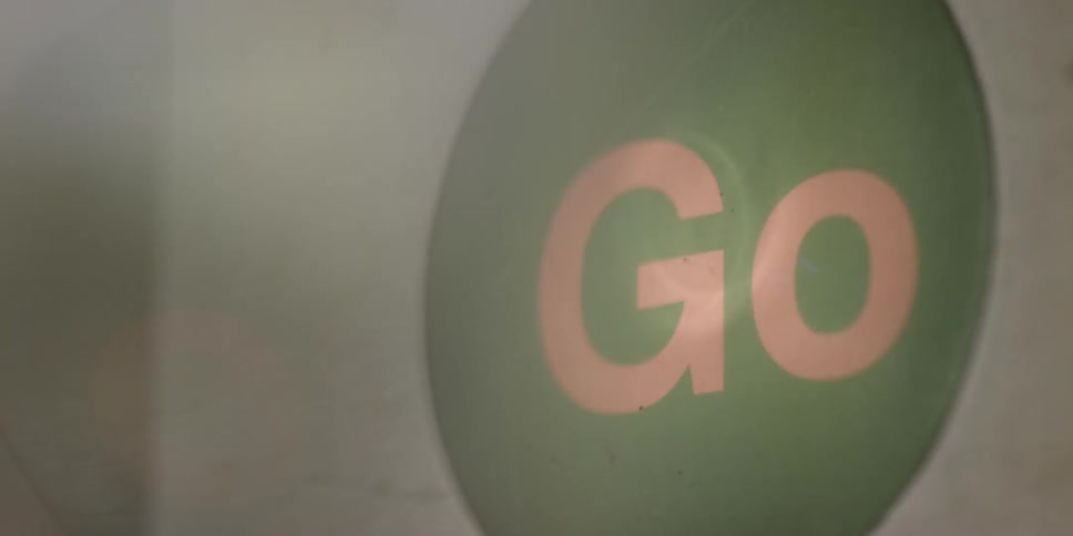A sign flashes the word 'go' on and off
