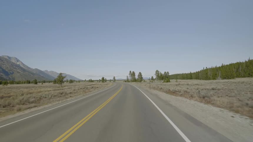 The road is long and winding on a sunny day