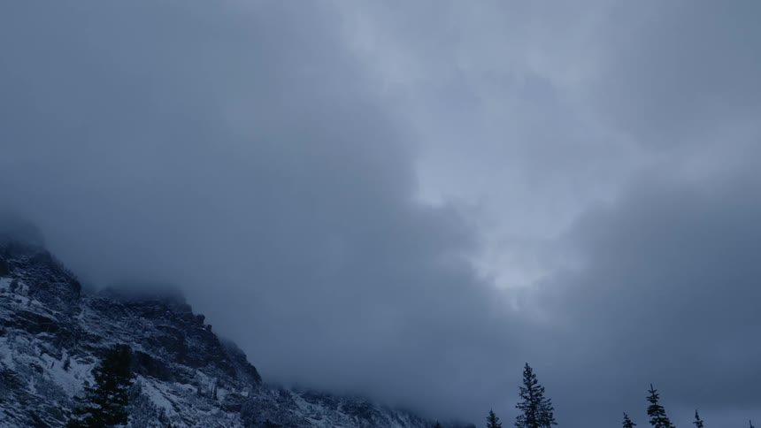 Dark clouds above a snowy mountain