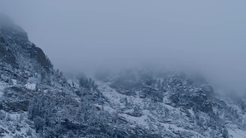 A scenery of a foggy and icy mountain