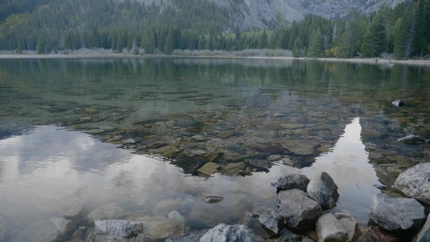 Lake water trickles by the rocky coast