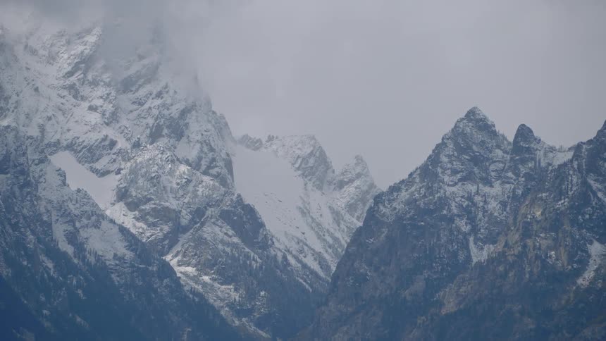 Snow dusted mountain ridges and peak on a gray day