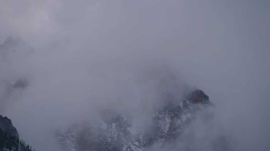 The clouds swirl around the mountain top