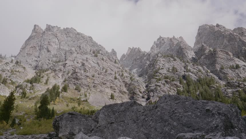 White clouds float over the mountains