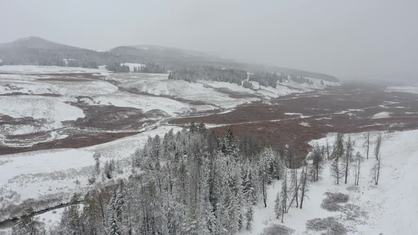 A wide hilly countryside covered in snow