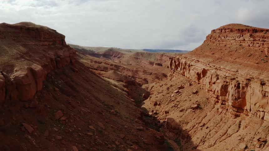 A canyon in the daytime with the sky in the background