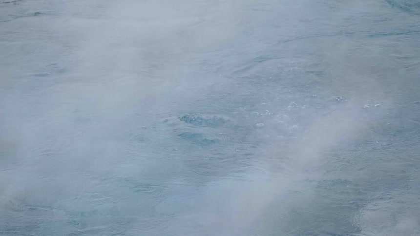 Smoke flows over the bubbling water