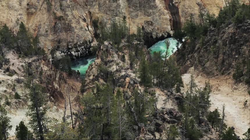 A body of water can be seen between a mountain range