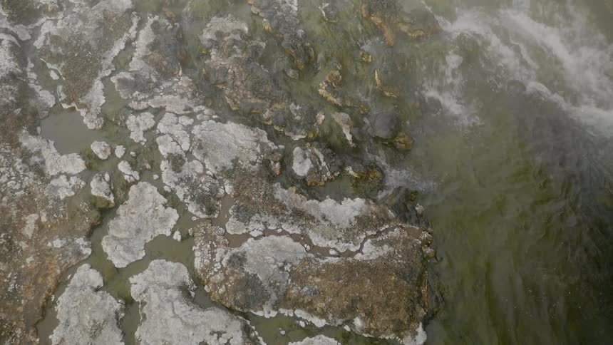 Water streams down rocks as a stream descends a rocky decline