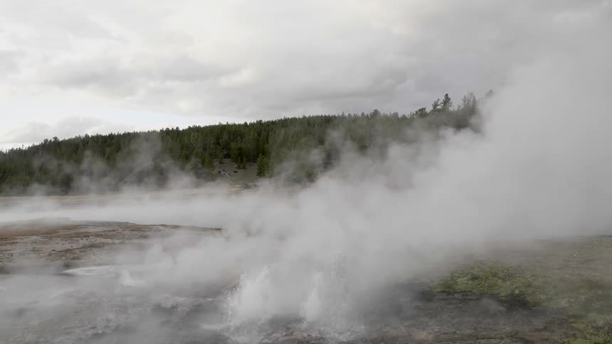 The steam rises from the spring near the hill