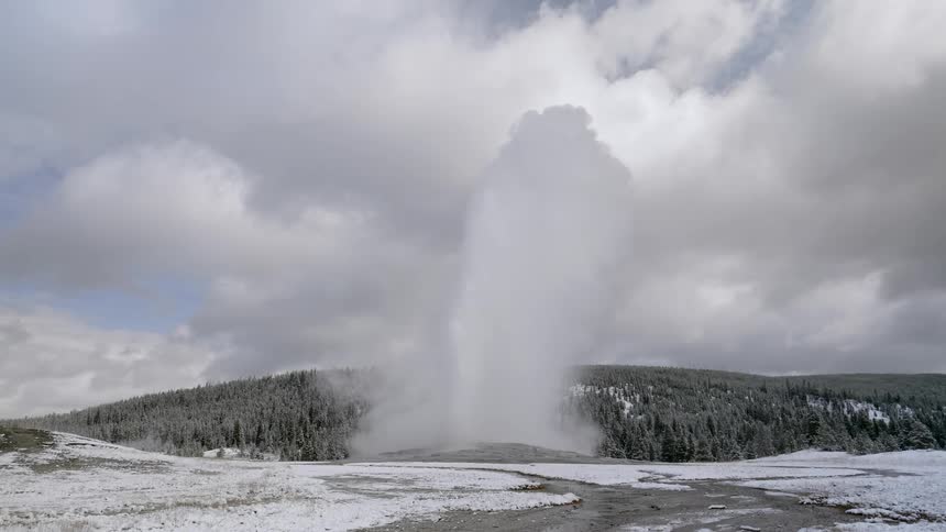 A geyser erupting out of a rocky area