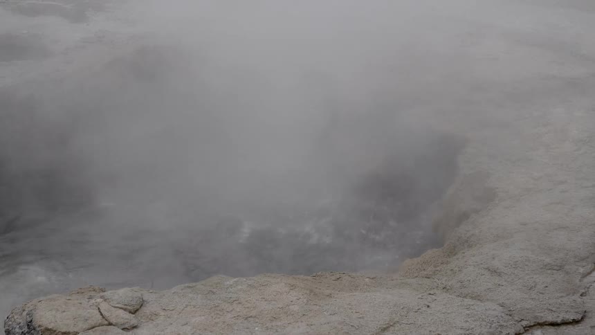 Hot springs water bubbling on the surface with steam