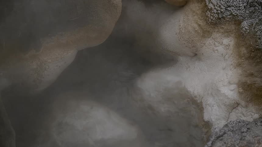 Seething hot spring of boiling water in a crater