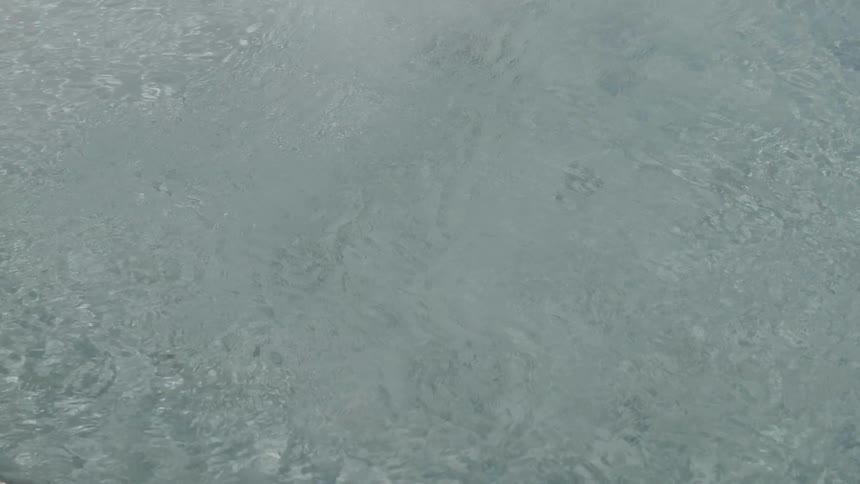 Rain falls onto the land below
