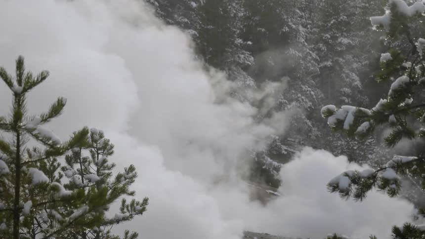 Steam rising from the surface of a snow covered mountain
