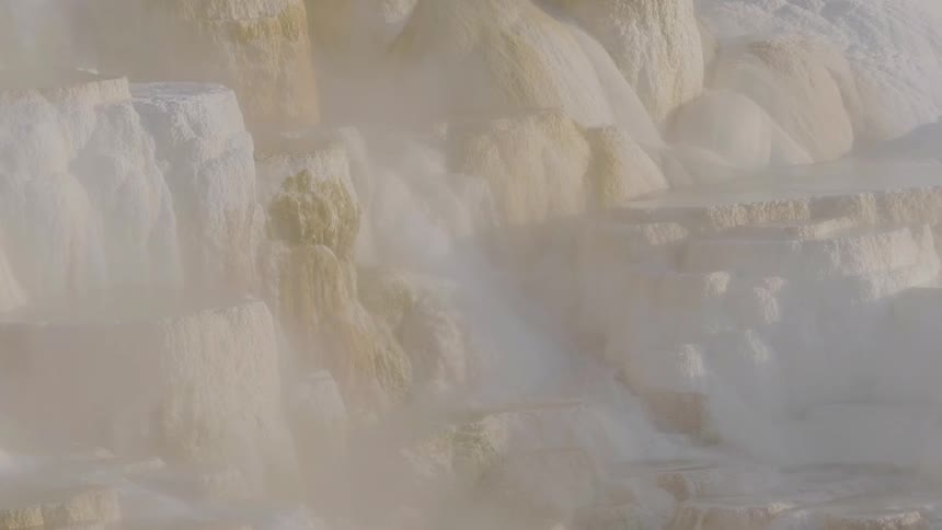 Water is cascading down the sides of many mineral deposits that have built up around a natural hot spring