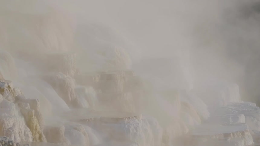 A waterfall on a mountain with mist