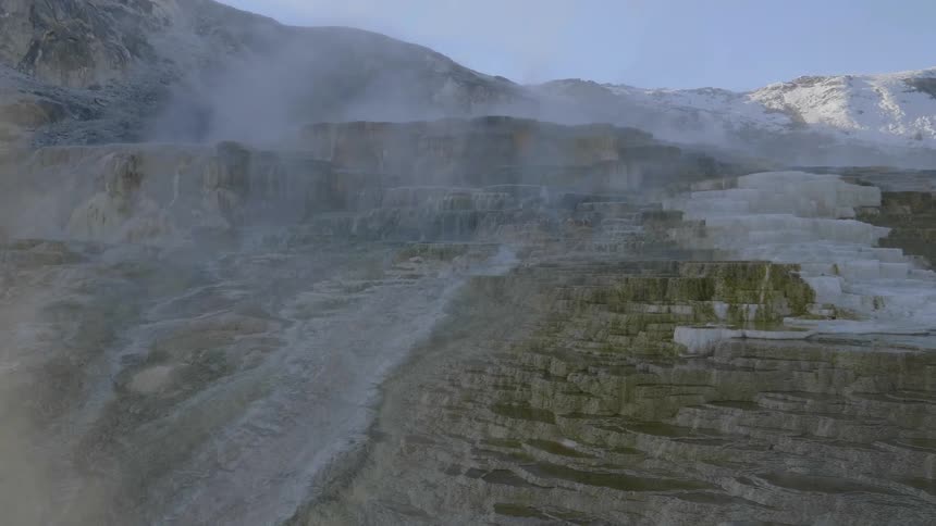 The hills are covered with mist and snow