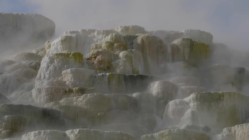 The steam rolls over the rocks