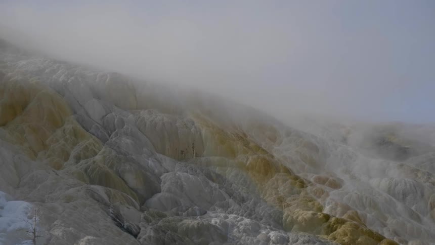 A static shot of a hill during a snowstorm