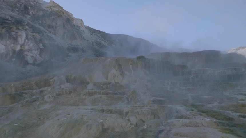Mountains and mountainous terrain surrounded by fog