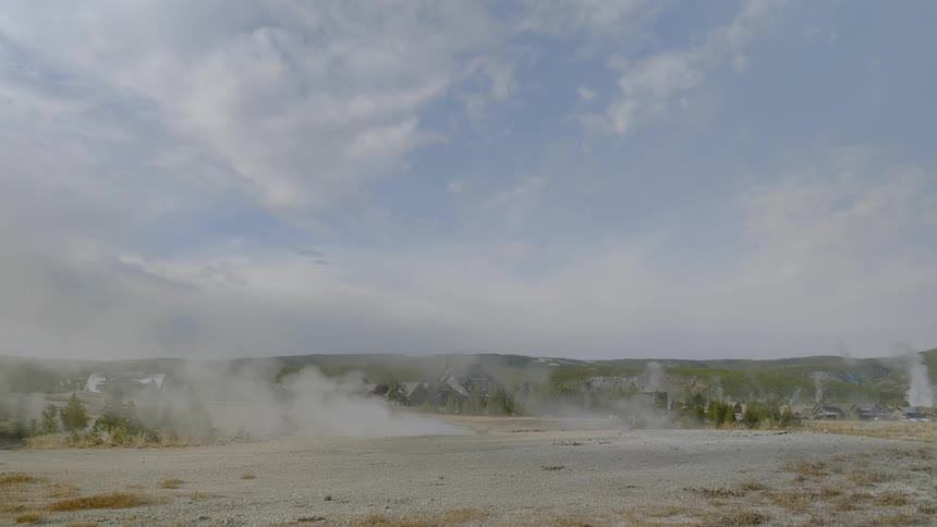 The steam rises on the field before the hills
