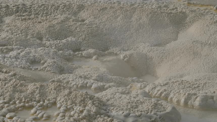 Haze blows across piles of mud
